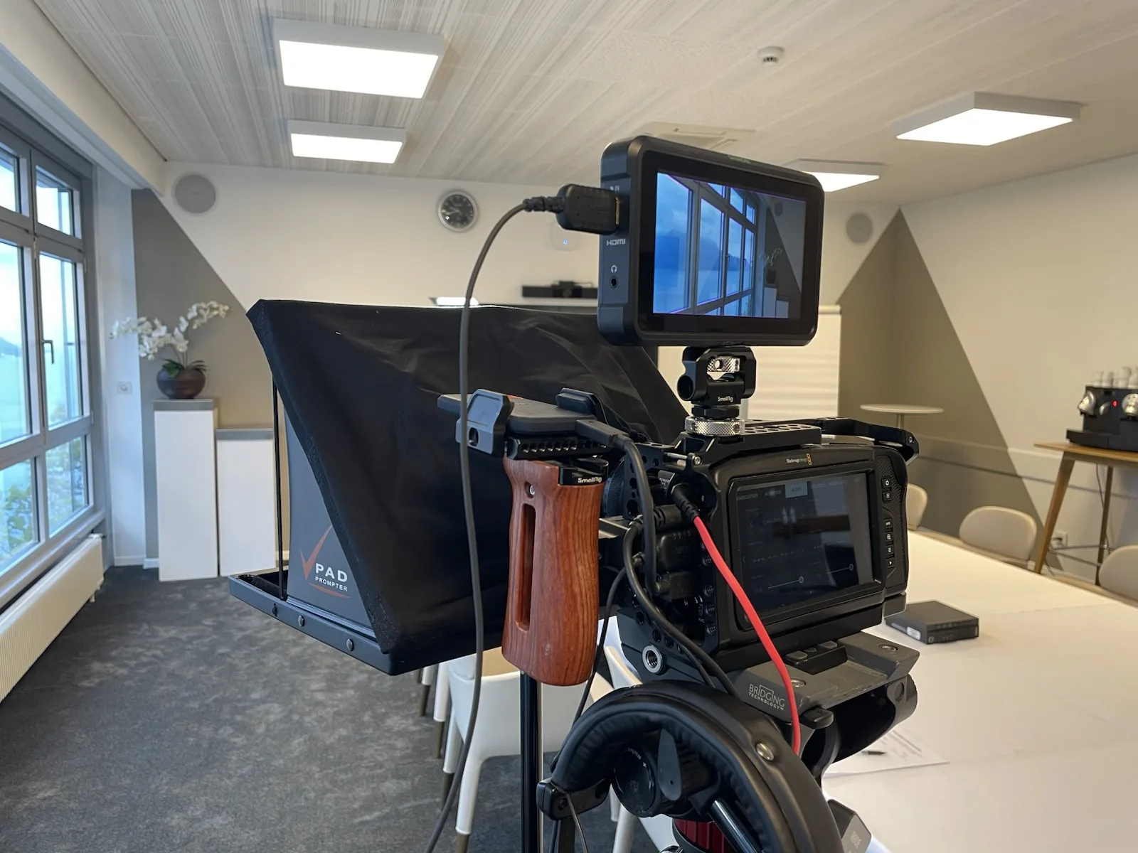 Camera, monitor and microphone prepared for a filmed interview.